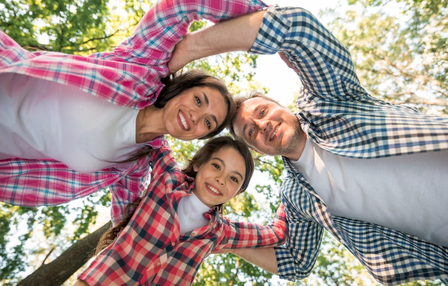 Smiling family gathered together outdoors