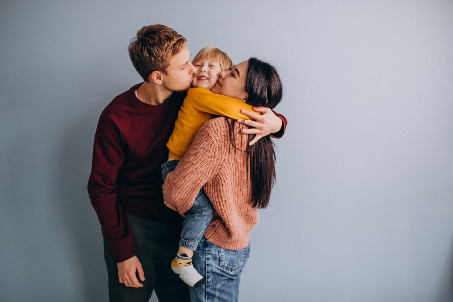 Parent smiling with two children