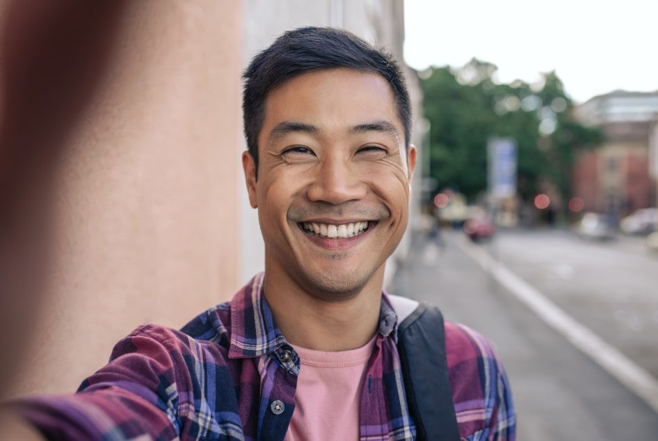 Smiling man outdoors on a city street